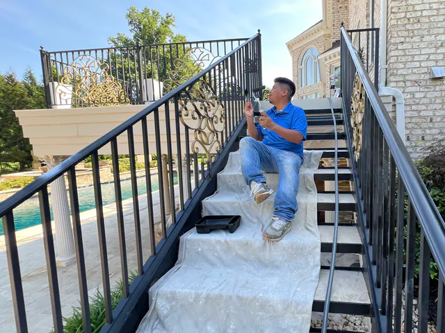 AG Renovation painter refinishing an exterior metal railing.