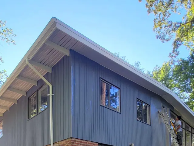 Exterior siding painting in progress.